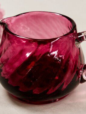 CS-12--Cranberry Ruby Red Art Glass Creamer – Draped Optic Pattern – Clear Handl